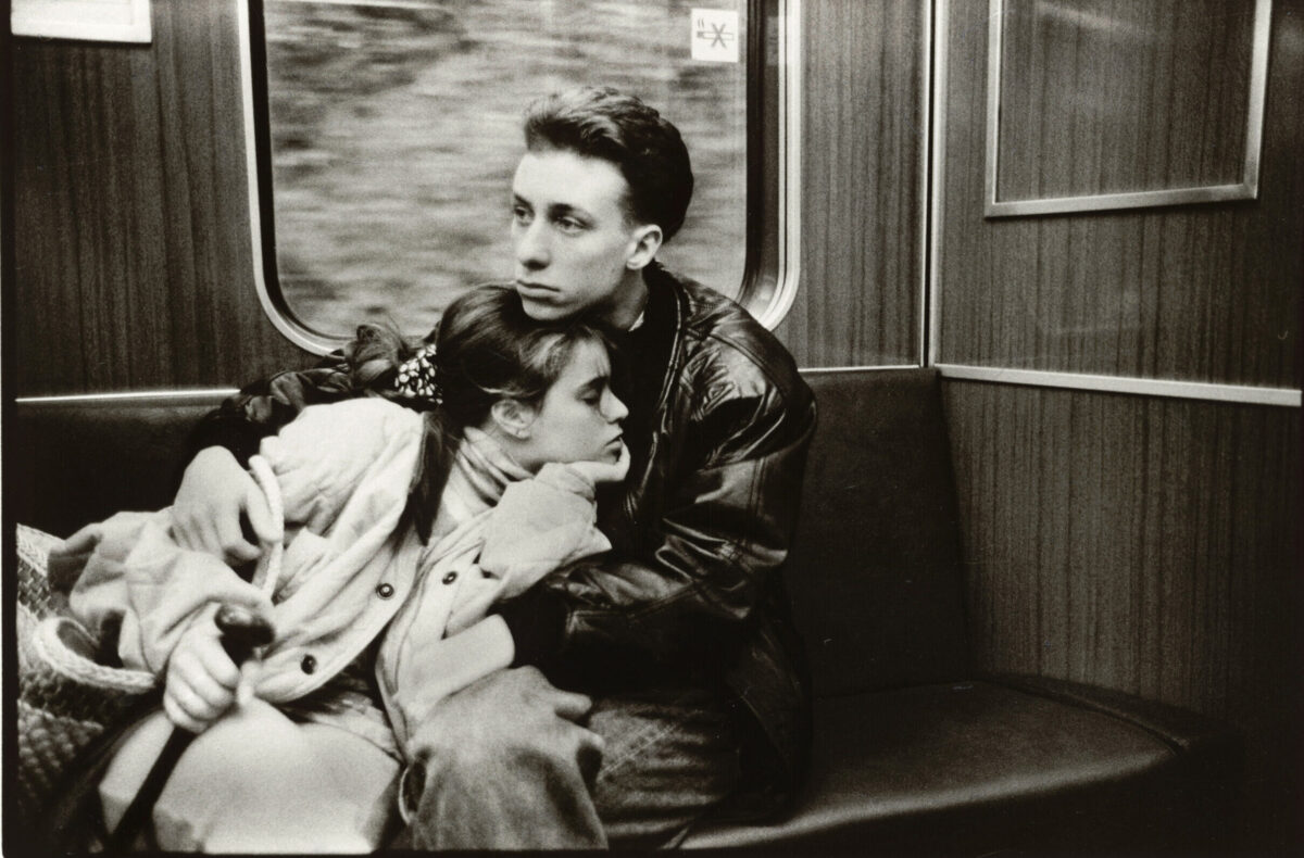 zwei Personen liegen sich in der Bahn im Arm